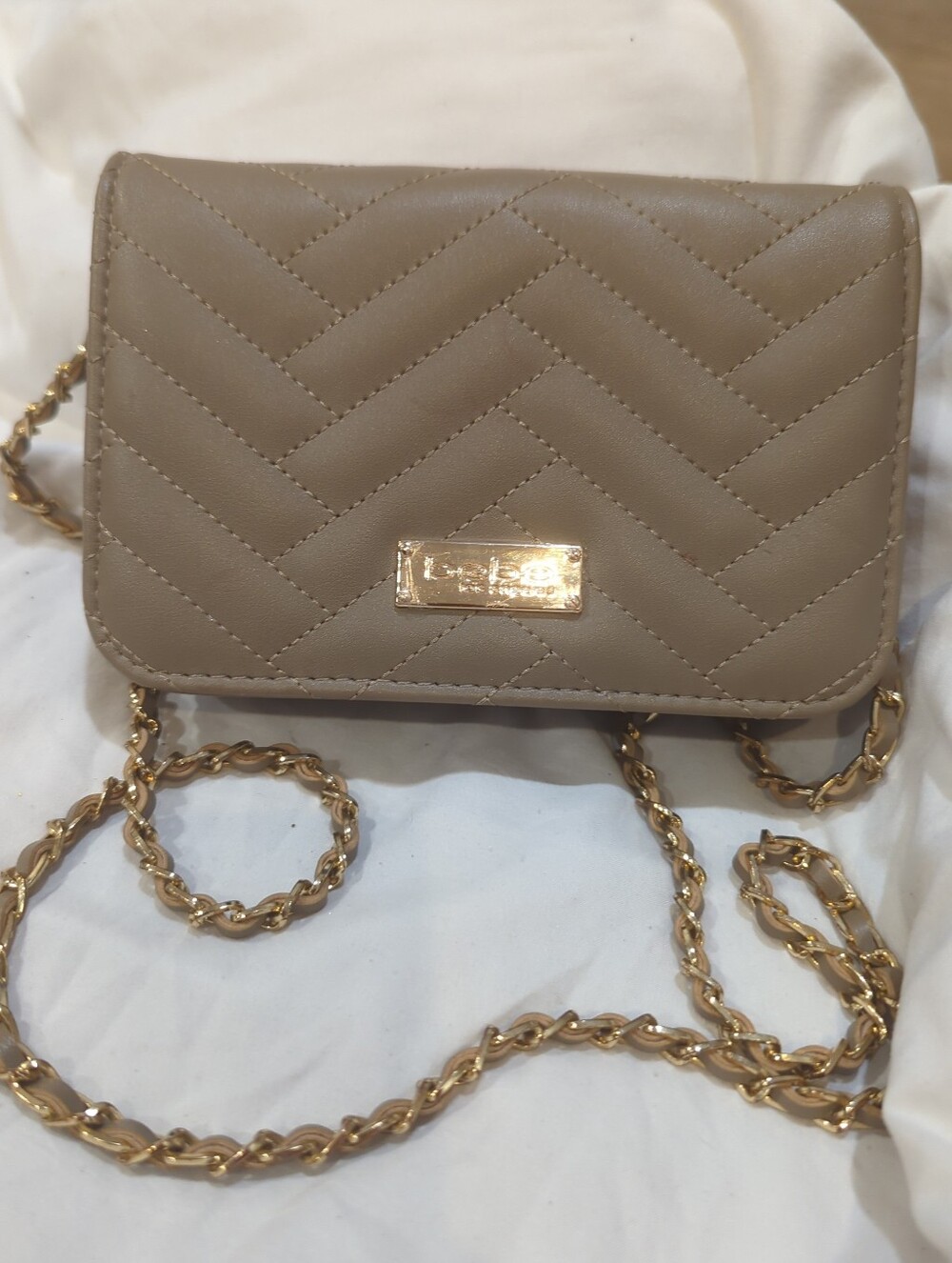 Stylish bebe Sophia wallet-on-chain crossbody bag in a taupe-gray color with che